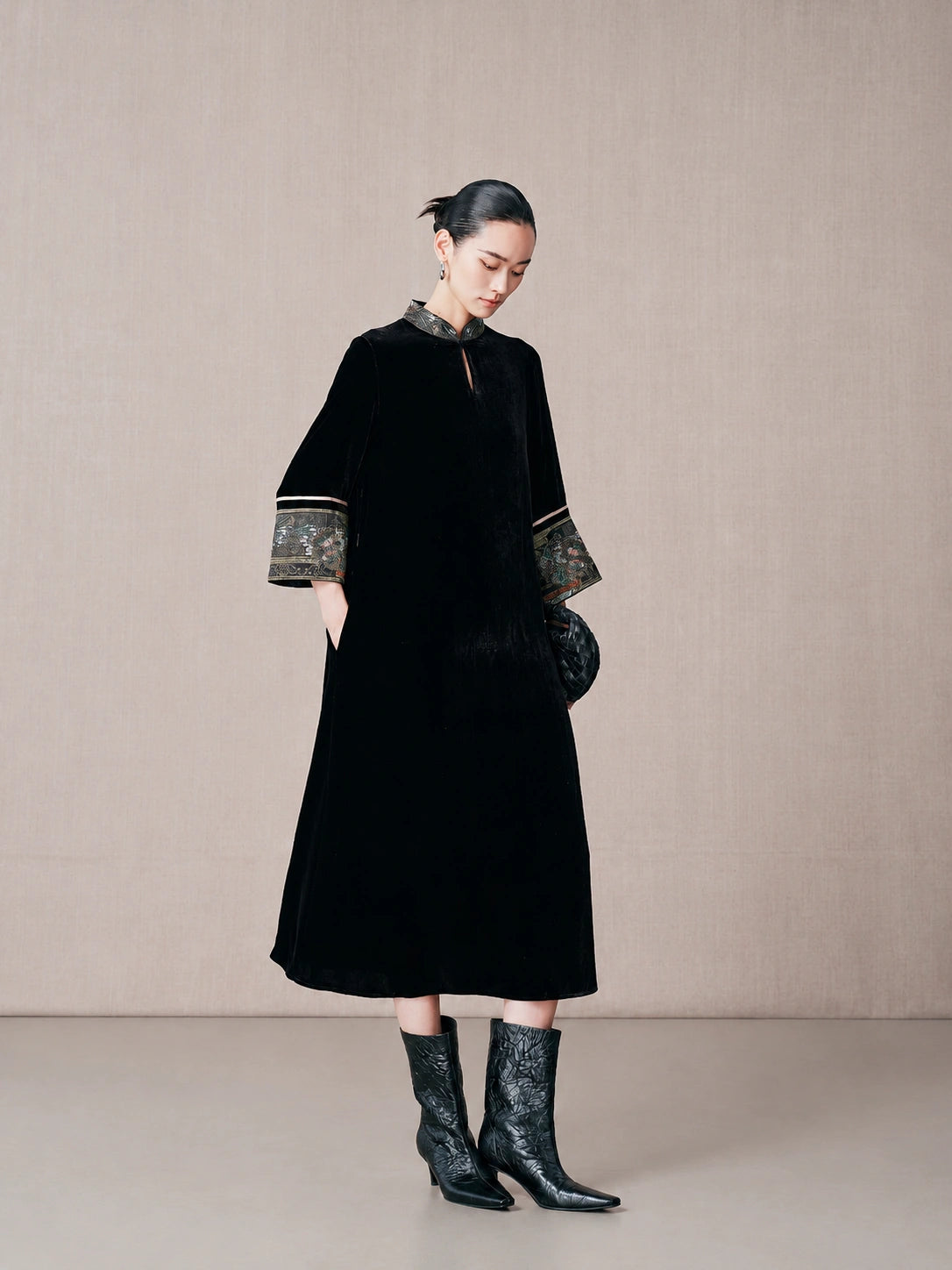 Side view of a black mulberry silk A-line dress with mandarin collar