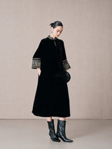 Side view of a black mulberry silk A-line dress with mandarin collar