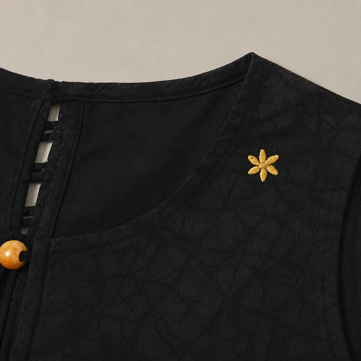 Detail of neckline and star embroidery on black mulberry silk Xiangyunsha dress