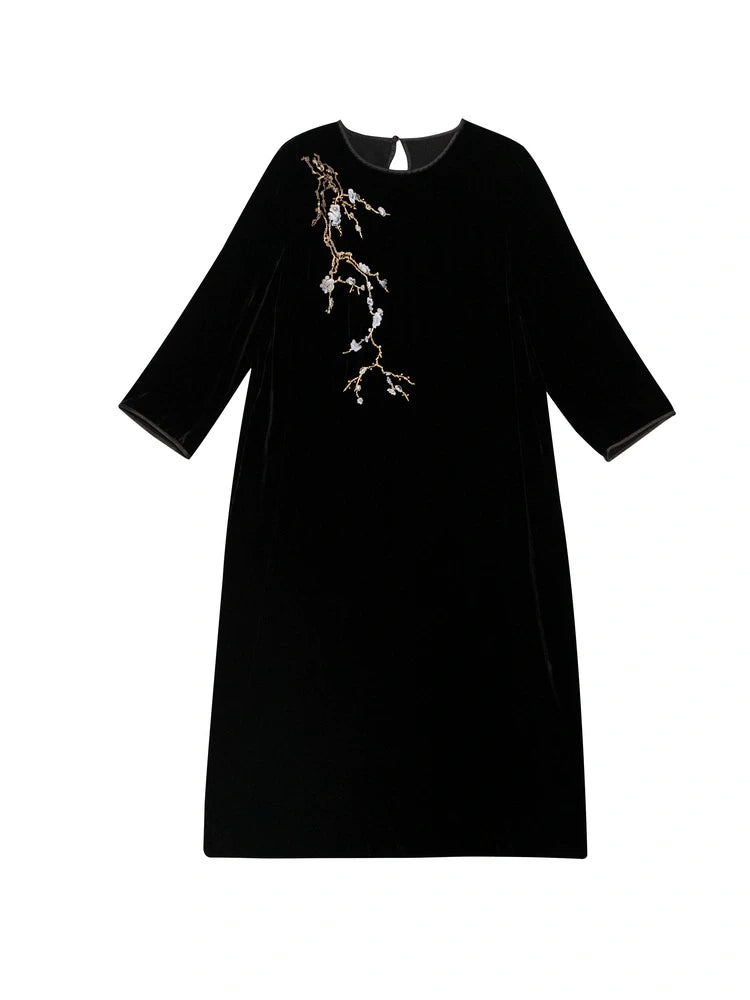 Flat lay of black mulberry silk midi dress featuring delicate floral branch embroidery.