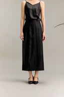 Black silk A-line midi skirt with intricate lace embroidery at the hem, crafted from 100% mulberry silk, featuring a textured jacquard finish and elasticated waist.