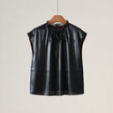Front product view of a black silk cap-sleeve blouse with a lace-trimmed neckline and self-tie