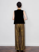 Back view of a model wearing a black sleeveless silk-base velvet Chinese-style vest.