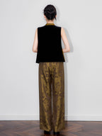 Back view of a model wearing a black sleeveless silk-base velvet Chinese-style vest.