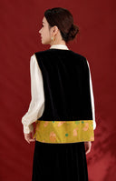 Back view of the black velvet vest with a golden olive band featuring pink rabbits.