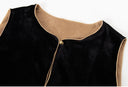 Close-up of the vest’s round neckline, tan piping, black velvet and gold-toned top button.