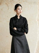 Minimalist black wrap blouse with Mandarin collar and long sleeves.