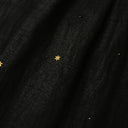 Close-up detail of black Xiangyunsha mulberry silk dress with delicate star embroidery texture