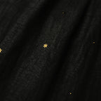 Close-up detail of black Xiangyunsha mulberry silk dress with delicate star embroidery texture