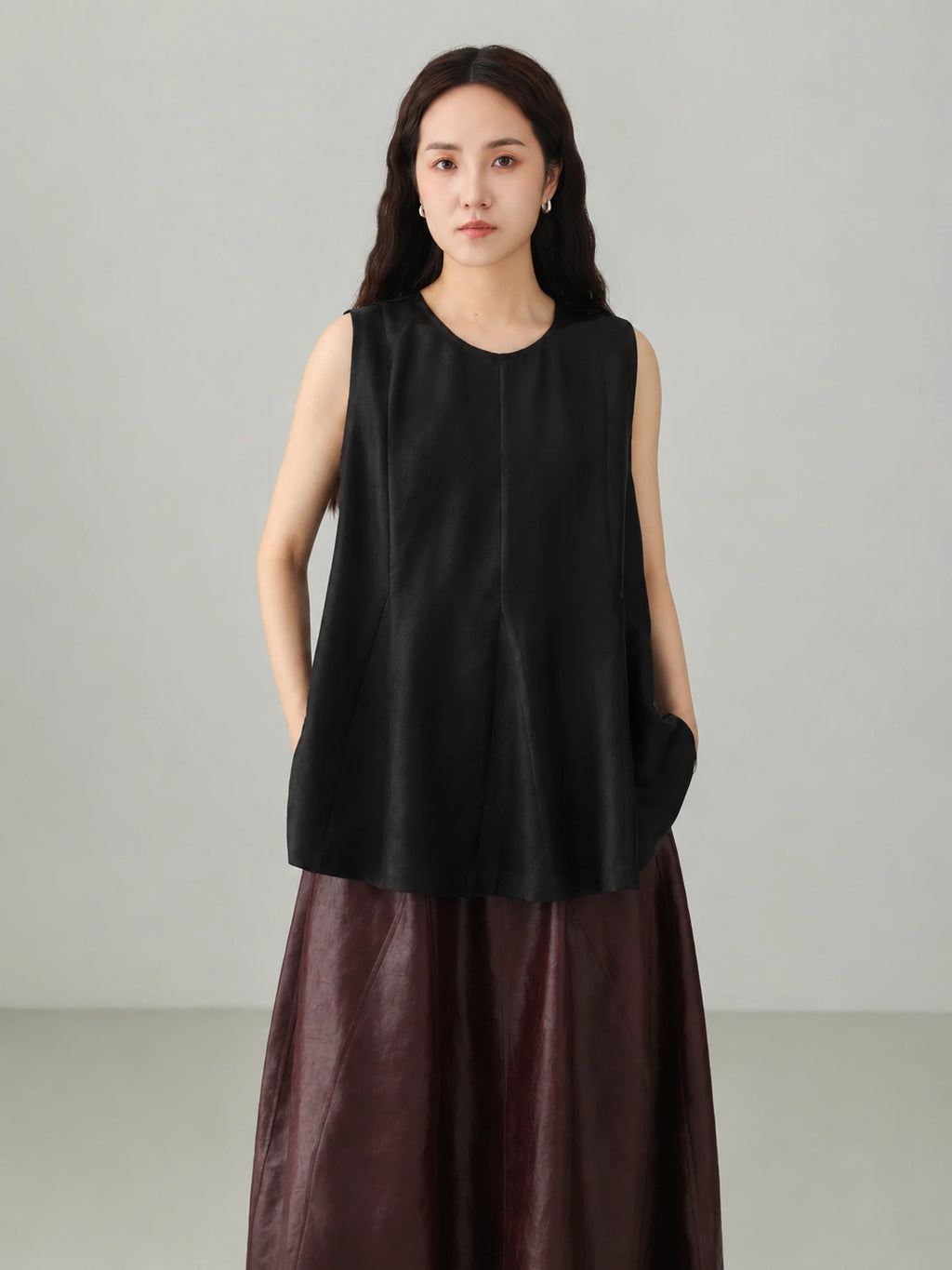 Close up detail of black Xiangyunsha silk jacquard sleeveless top showing traditional Chinese textile texture
