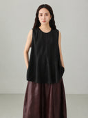 Close up detail of black Xiangyunsha silk jacquard sleeveless top showing traditional Chinese textile texture