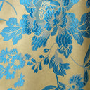 Close-up of the blue floral jacquard pattern woven into lustrous gold fabric