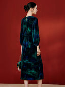 Back view of the blue midi dress with balloon sleeves and a tied waist