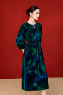 Side view of the blue midi dress showing its gathered neckline and A-line skirt