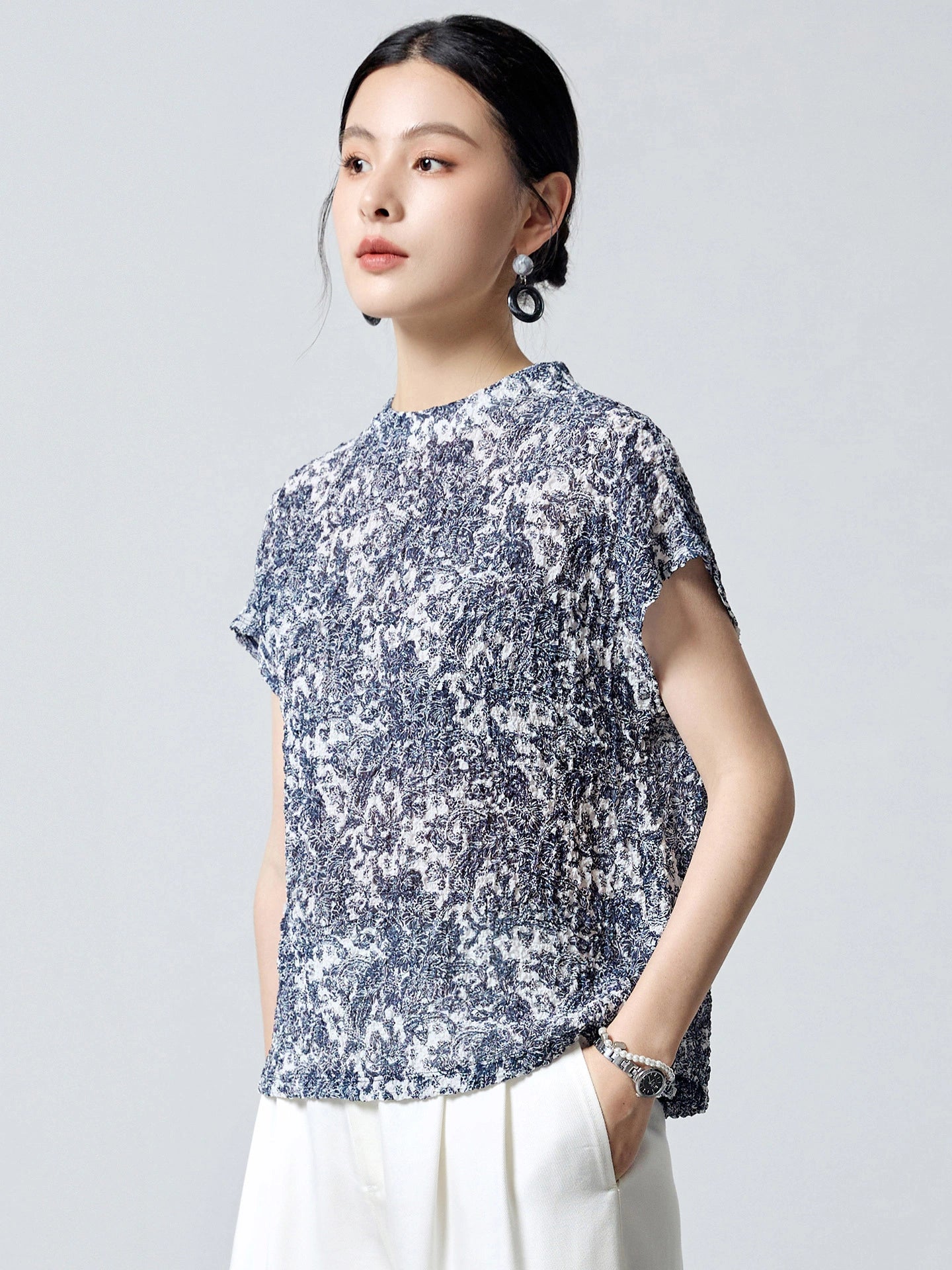 Front view of a short sleeve blue and white printed silk blouse with a relaxed silhouette and soft drape, perfect for summer styling.