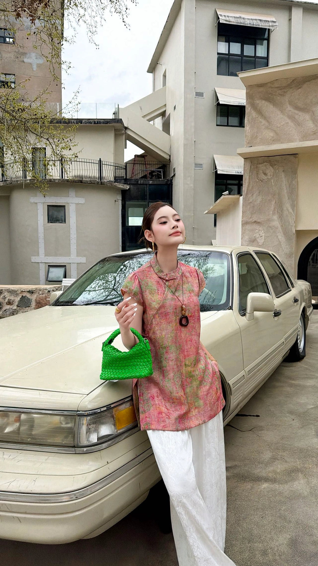 Side view of a pink sleeveless Cheongsam blouse with a relaxed fit, highlighting the breathable viscose-nylon blend and elegant drape.