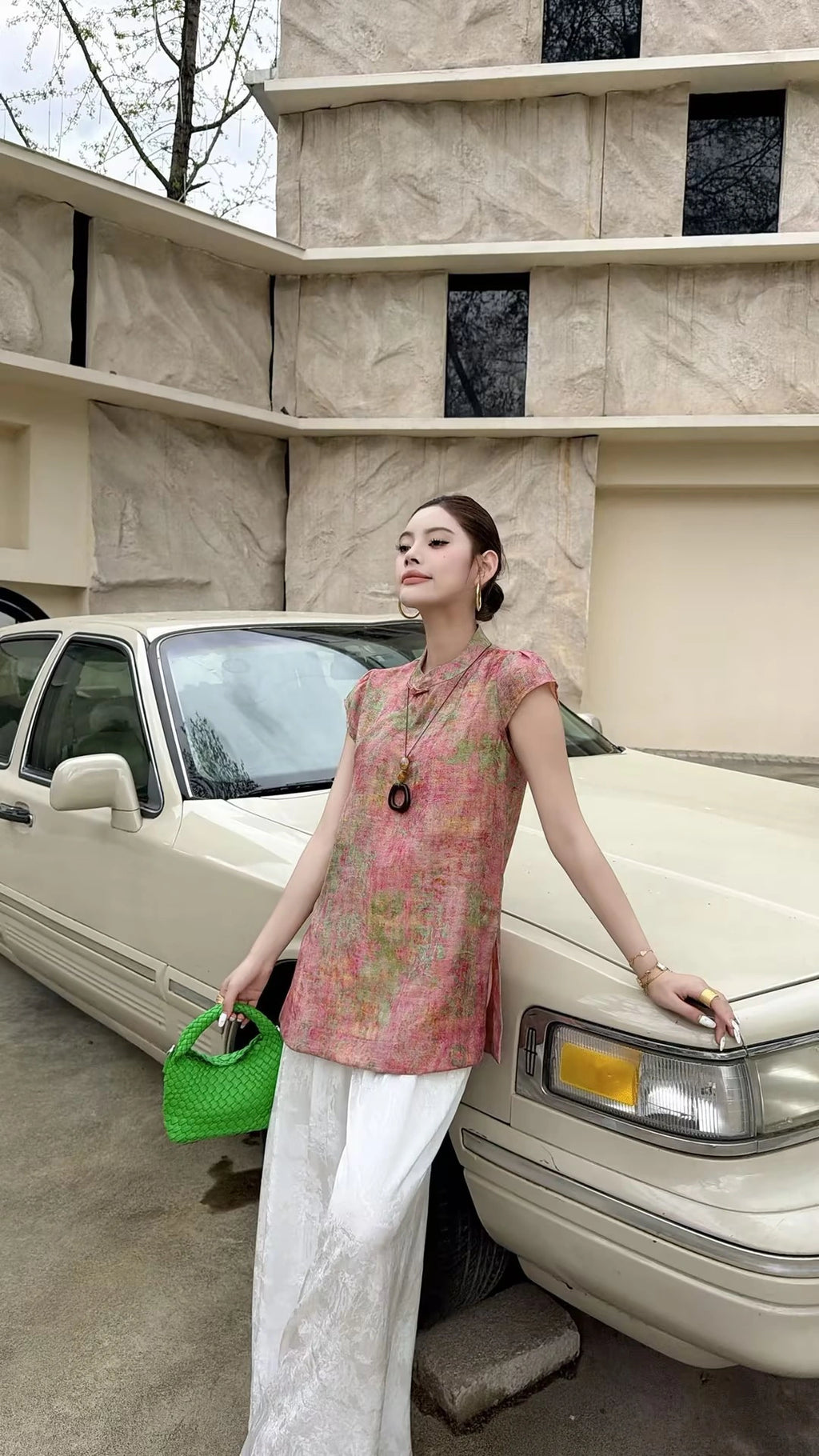 Side view of a pink sleeveless Cheongsam blouse with a relaxed fit, highlighting the breathable viscose-nylon blend and elegant drape.