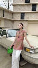 Side view of a pink sleeveless Cheongsam blouse with a relaxed fit, highlighting the breathable viscose-nylon blend and elegant drape.
