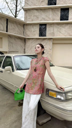 Side view of a pink sleeveless Cheongsam blouse with a relaxed fit, highlighting the breathable viscose-nylon blend and elegant drape.
