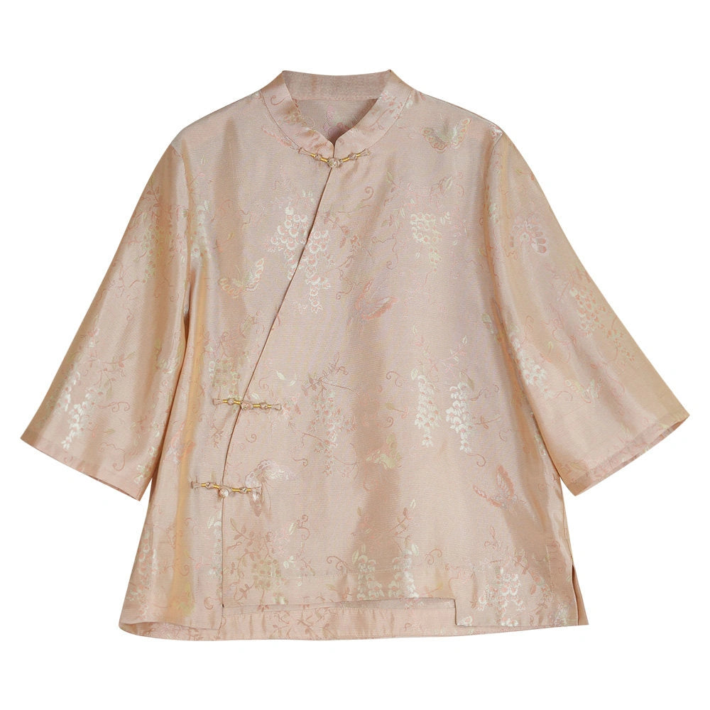 Front product view of a blush pink floral jacquard silk blouse with a Mandarin collar and handmade frog buttons
