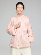Close-up of the stand collar, pearl-style buttons and floral jacquard texture on the blush pink padded jacket