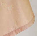 Close-up of the butterfly and floral jacquard pattern at the three-quarter sleeve hem