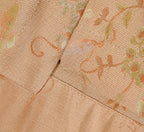 Close-up of the side slit, layered hem and botanical jacquard texture on the pink silk blouse