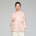 Front view of a blush pink wool and mulberry silk jacquard padded jacket with stand collar and patch pockets