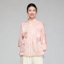 Front view of a blush pink wool and mulberry silk jacquard padded jacket with stand collar and patch pockets