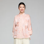 Front view of a blush pink wool and mulberry silk jacquard padded jacket with stand collar and patch pockets