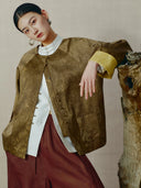 Front view of a bronze mulberry silk-blend jacket showing knotted buttons, bamboo motifs and patch pockets.