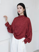 Burgundy Cross-Over Mandarin Collar Blouse styled with white trousers.