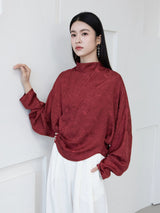 Burgundy Cross-Over Mandarin Collar Blouse styled with white trousers.