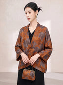 Model wearing a Burnt Orange floral silk jacket over a black outfit