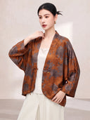 Model wearing the floral silk jacket open, showing its V-neckline and wide sleeves