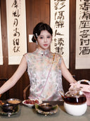 Model seated in a relaxed H-line dress with a pastel butterfly print and sleeveless design