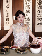 Model seated in a relaxed H-line dress with a pastel butterfly print and sleeveless design