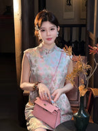 Close-up of a butterfly print silk blend dress with a stand collar and delicate pink pattern