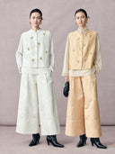 Ivory white and champagne beige butterfly-embroidered wool-silk vests shown together