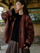 Closer view of the Canglan jacket’s loose sleeve, patterned fabric and embroidered front edge.