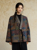 Front view of the Cangmo jacket showing its multicolor motifs, decorative neckline trim and hanging ties.