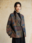 Closer view of the Cangmo jacket showing paisley and geometric motifs with beaded and embroidered neckline trim.