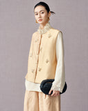 Three-quarter view of the champagne beige vest with butterfly embroidery