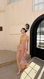 Side view of a champagne gold New Chinese style co-ord set, highlighting the subtle jacquard texture and side slit detail on the maxi skirt.