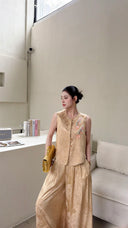 Side view of a New Chinese style co-ord set in beige gold, with embroidered vest and flowy wide-leg pants.