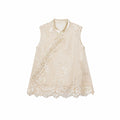 Flat lay of a champagne gold sleeveless vest with bead embroidery, scalloped lace hem, and traditional side button closures.
