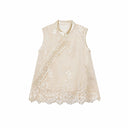 Flat lay of a champagne gold sleeveless vest with bead embroidery, scalloped lace hem, and traditional side button closures.
