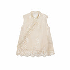 Flat lay of a champagne gold sleeveless vest with bead embroidery, scalloped lace hem, and traditional side button closures.