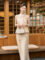 Model wearing a champagne sleeveless top with scattered flowers and matching skirt, sitting by a wooden window, showcasing the elegant Lyocell-Tencel blend.