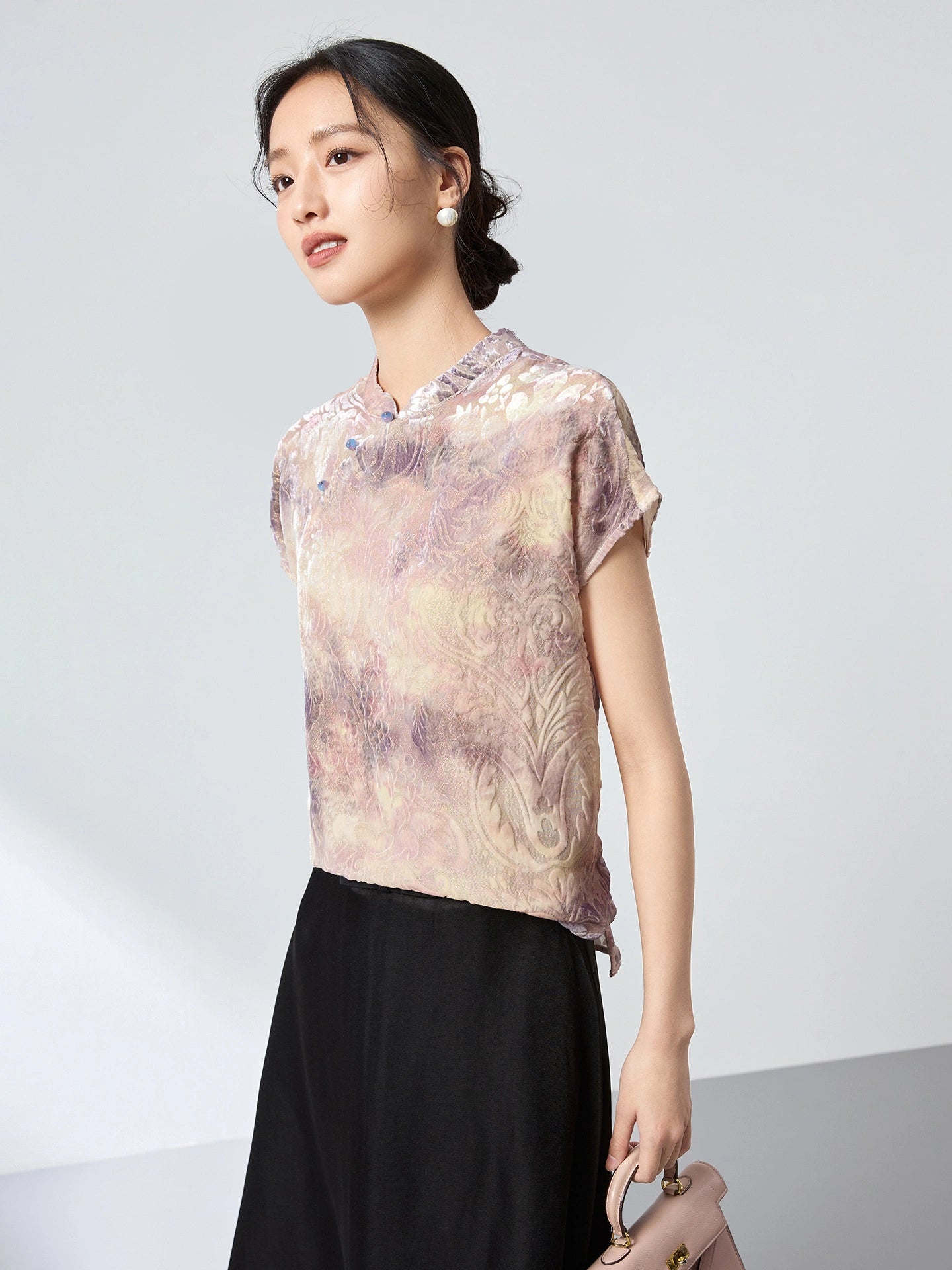Front view of a champagne New Chinese Style top with a stand collar and frog buttons, showcasing the unique flocking texture and romantic abstract print.
